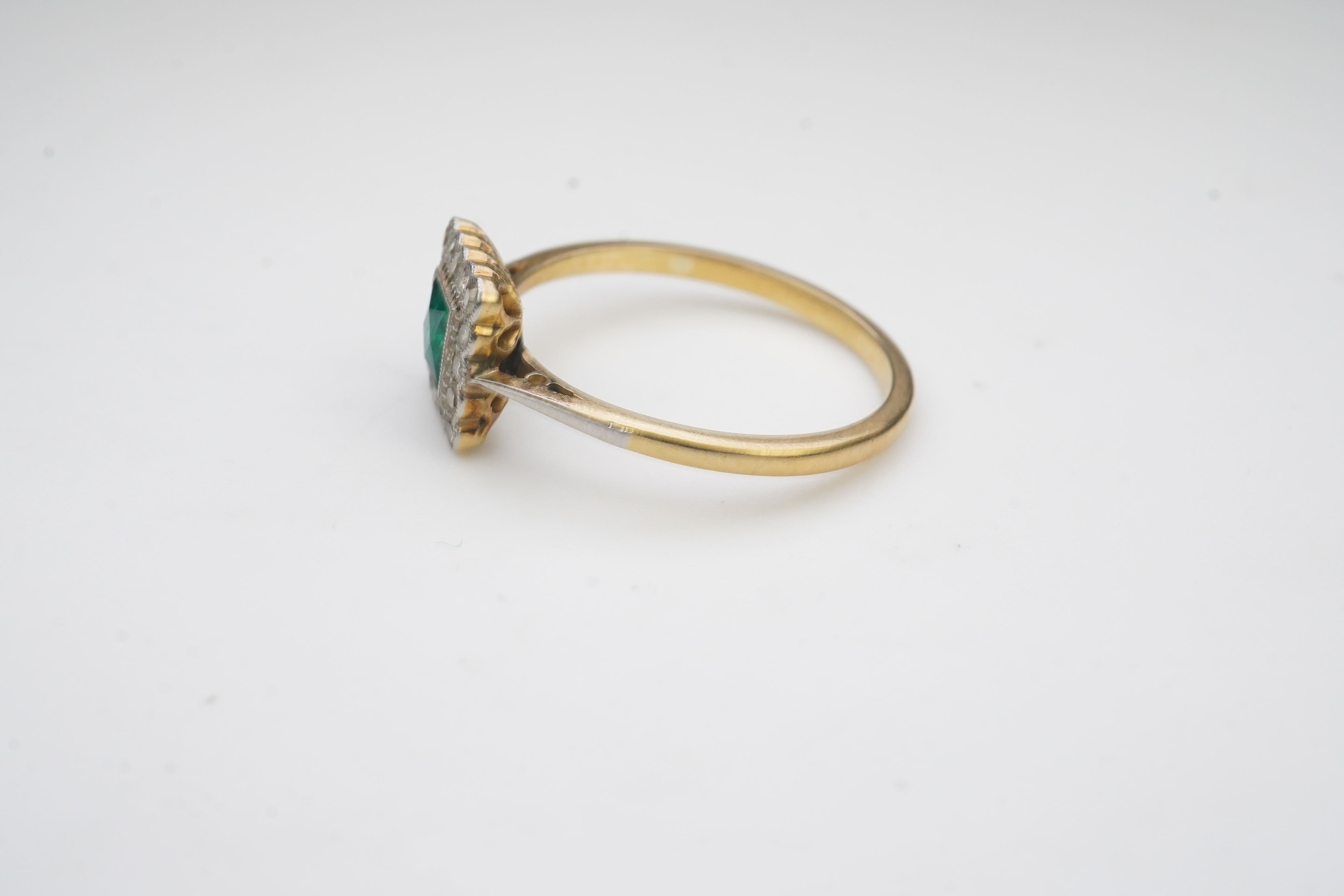 An emerald and diamond ring, early 20th century